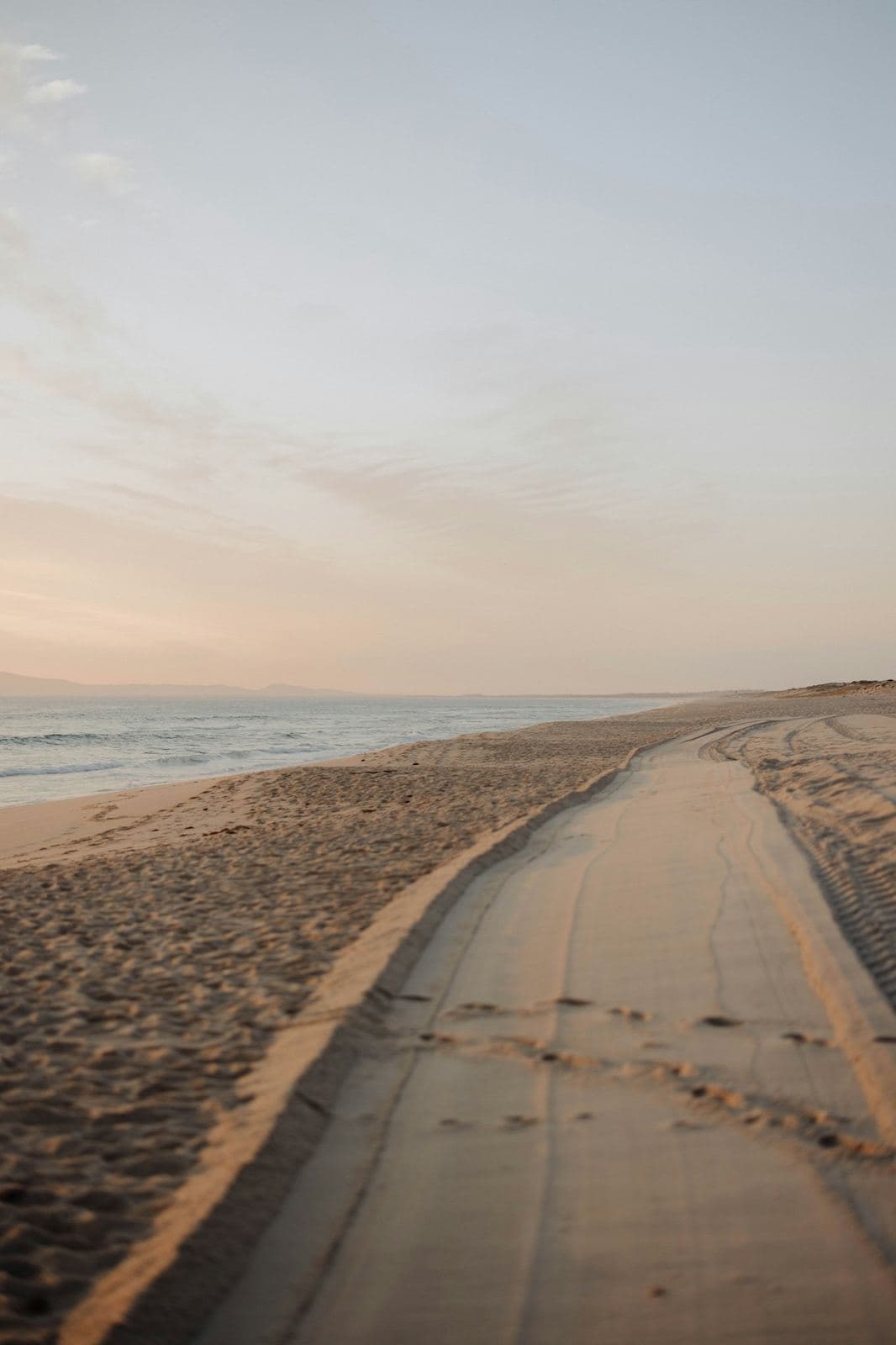 An empty dune-backed beach in Comporta at dusk