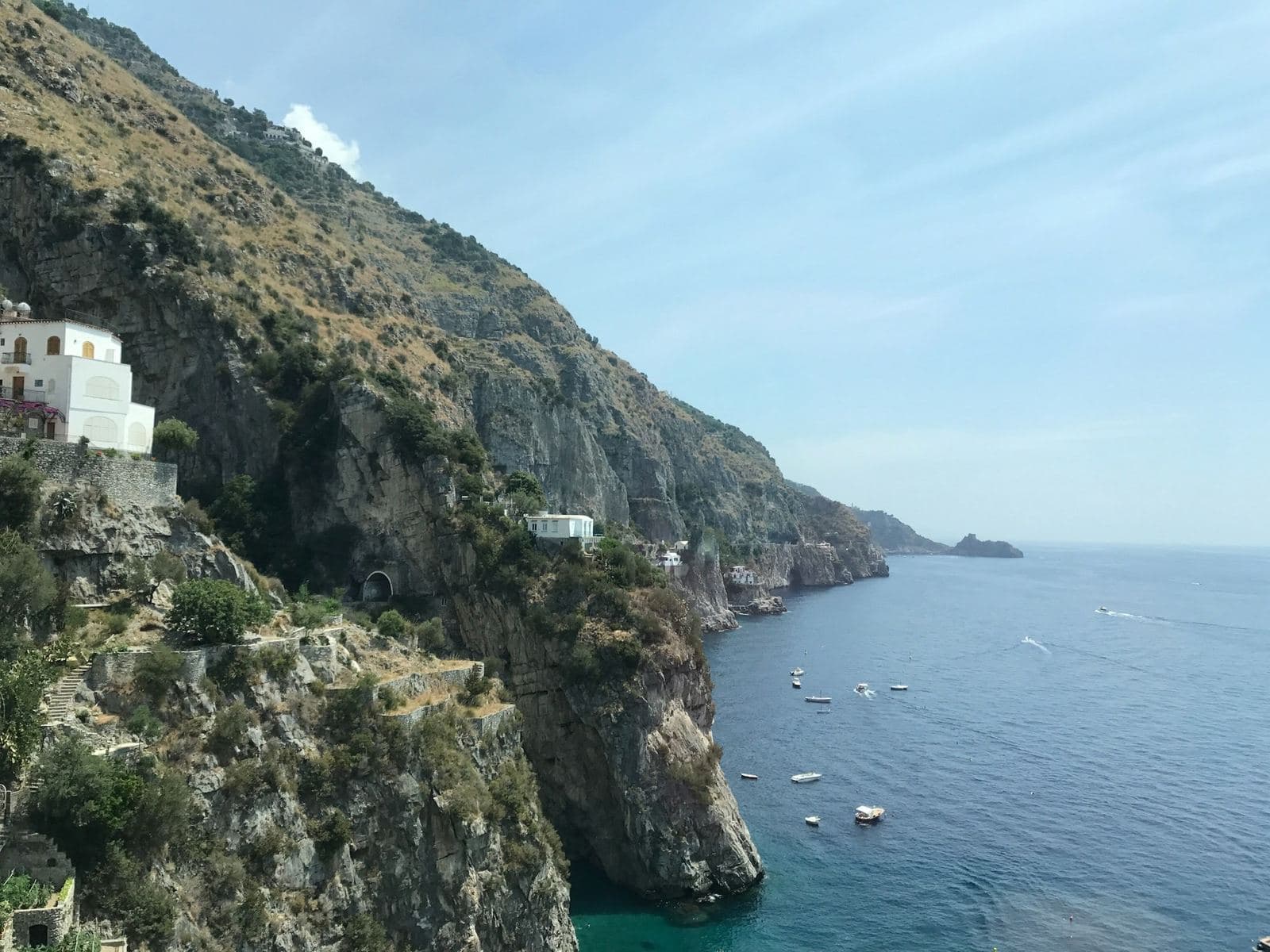 Green cliffs dropping into the sea on the Amalfi Coast