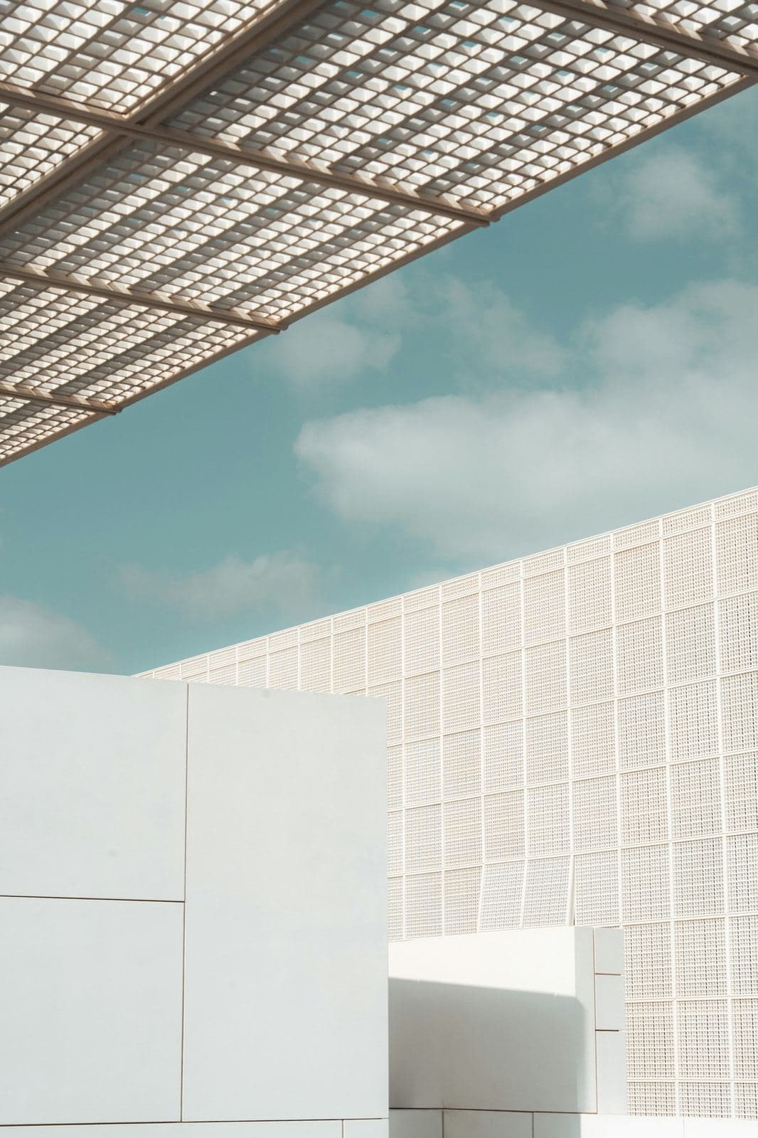 Minimal white architecture under a latticed canopy