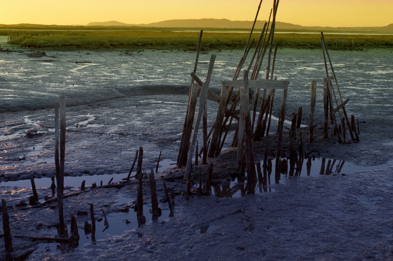 The weathered stilt pier at Carrasqueira near Comporta at dusk