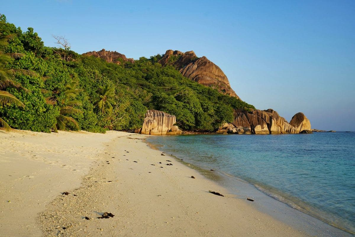 A quiet beach backed by granite hills