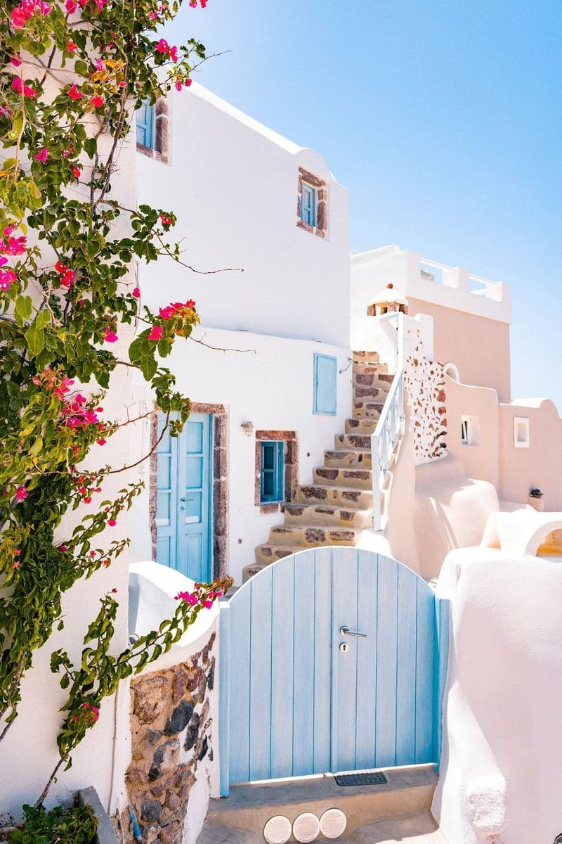 A blue gate on a whitewashed lane