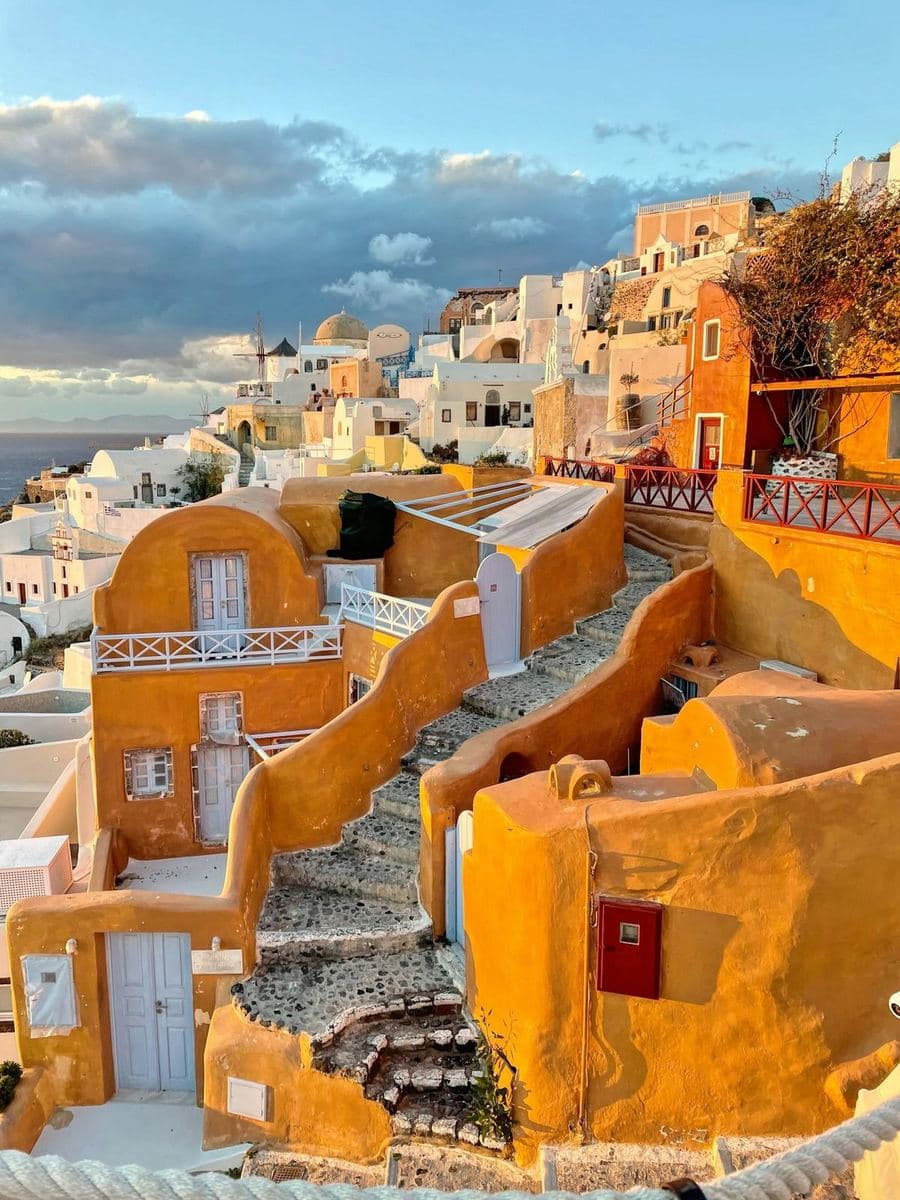 Ochre and white houses stepping down the cliff